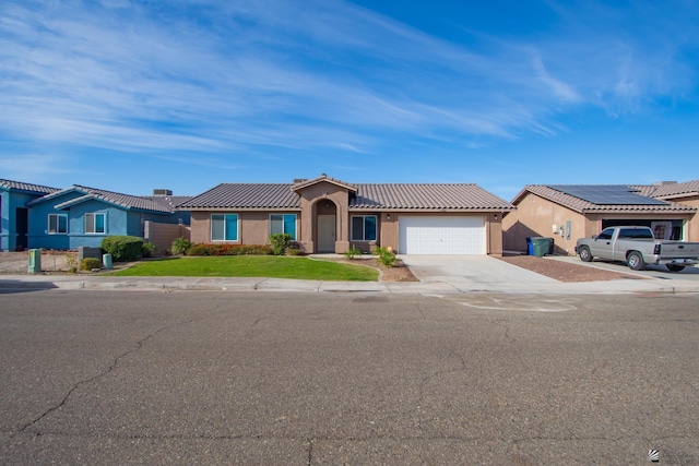 view of front facade with a garage, a tile roof, driveway, stucco siding, and a front lawn