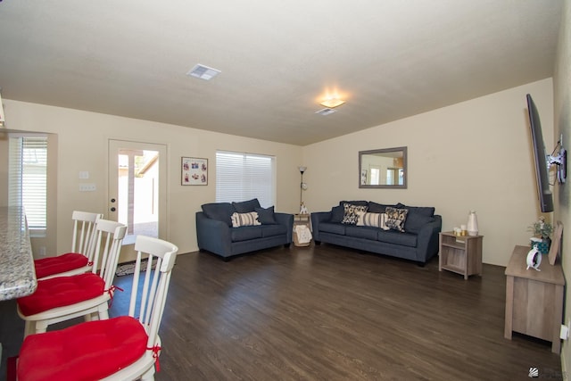 living area featuring dark wood-style floors and visible vents