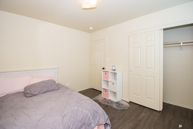 bedroom featuring a closet, baseboards, and wood finished floors