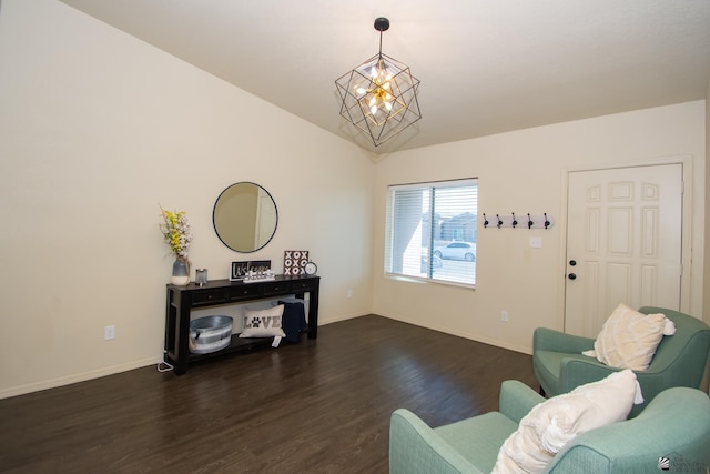 sitting room with lofted ceiling, an inviting chandelier, baseboards, and wood finished floors