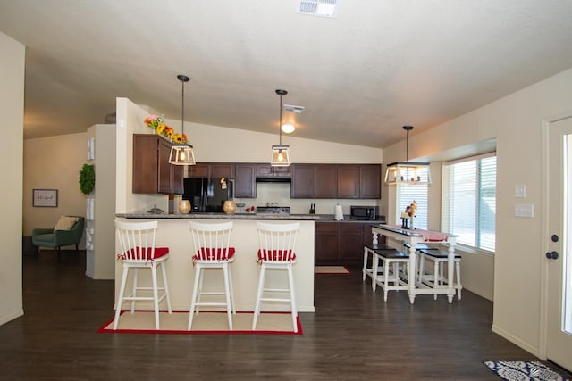 kitchen featuring dark wood-style floors, lofted ceiling, visible vents, a peninsula, and black appliances