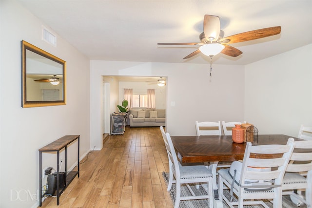 dining room with visible vents, ceiling fan, and light wood-style flooring