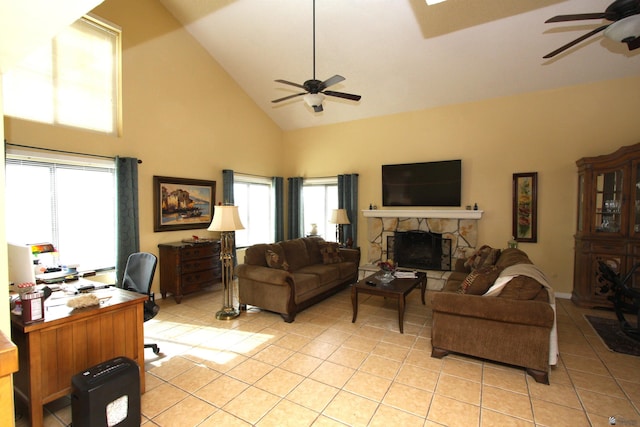 tiled living room featuring a wealth of natural light, ceiling fan, and a fireplace