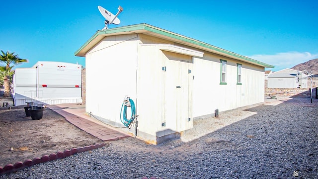 view of property exterior featuring a storage unit