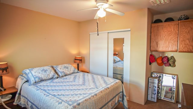 carpeted bedroom featuring a closet and ceiling fan