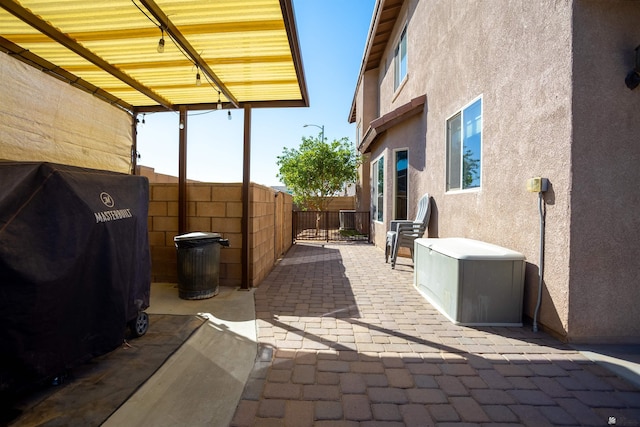 view of patio / terrace featuring grilling area and fence