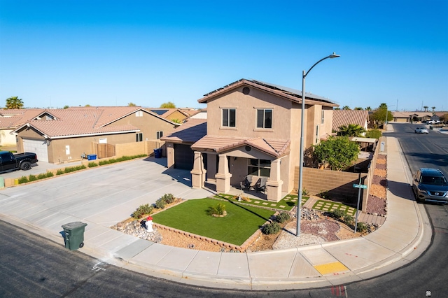 view of front facade featuring solar panels, fence, a residential view, a tiled roof, and driveway