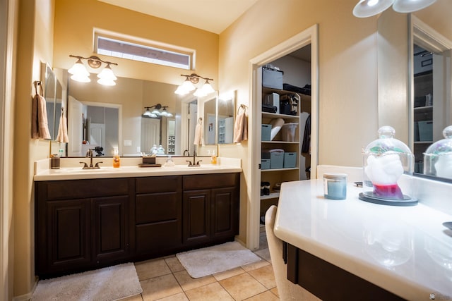 bathroom with a sink, double vanity, and tile patterned floors