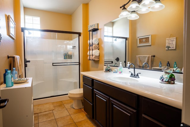 full bathroom featuring toilet, a stall shower, an inviting chandelier, tile patterned floors, and vanity