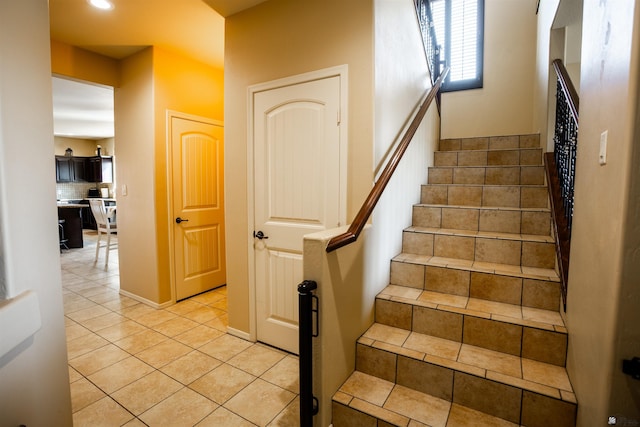 stairway with tile patterned flooring and recessed lighting