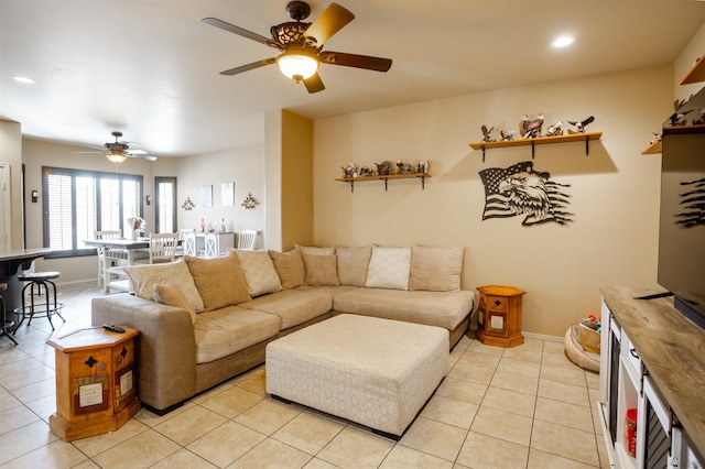 living room featuring light tile patterned floors, recessed lighting, baseboards, and ceiling fan