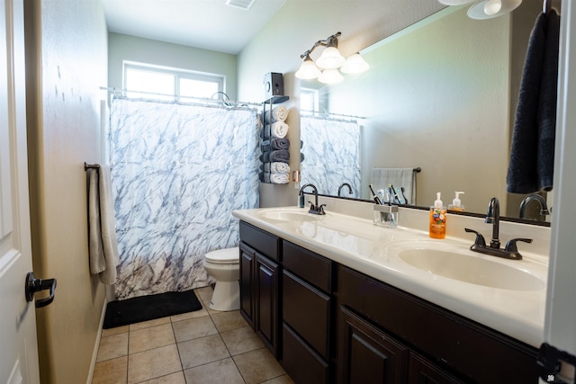 bathroom featuring a sink, a shower with curtain, toilet, and tile patterned floors