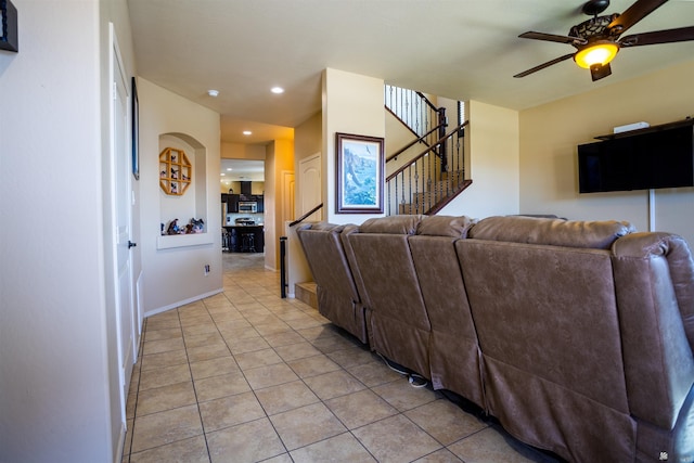 living room featuring light tile patterned floors, a ceiling fan, baseboards, recessed lighting, and stairs