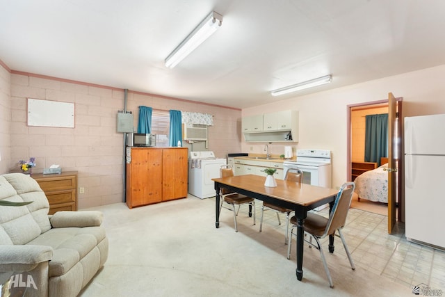 dining room featuring separate washer and dryer and sink