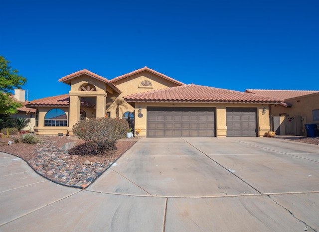 mediterranean / spanish-style house featuring a garage