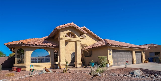 mediterranean / spanish-style home with a garage