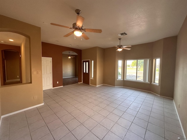 tiled spare room featuring ceiling fan and a textured ceiling