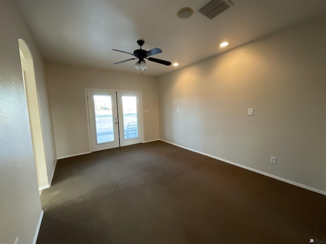 carpeted empty room with ceiling fan and french doors