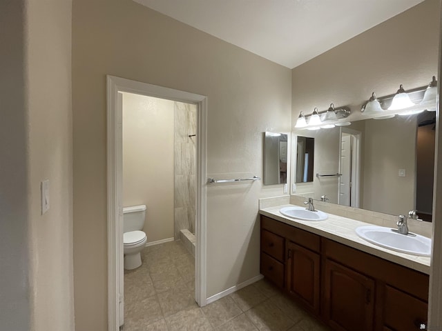 bathroom featuring a shower, vanity, and toilet