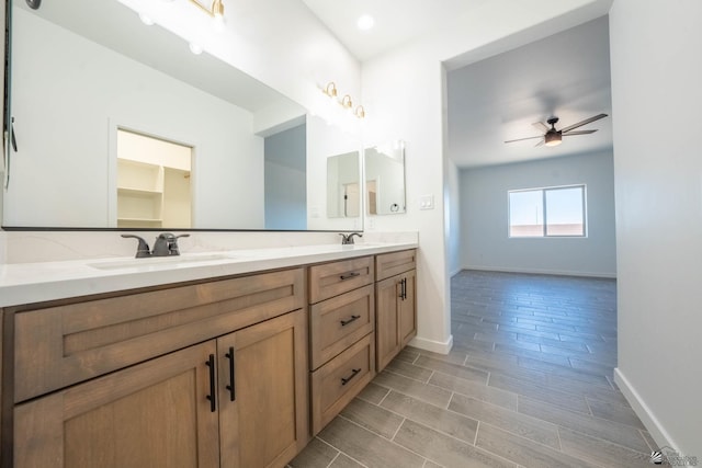 bathroom featuring ceiling fan and vanity