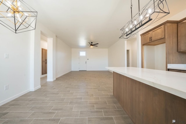 interior space featuring ceiling fan and hanging light fixtures