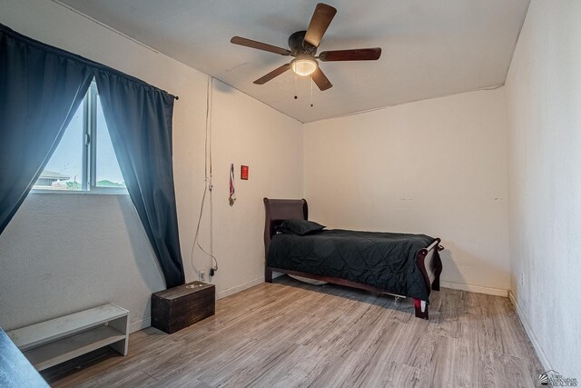 bedroom featuring light hardwood / wood-style flooring and ceiling fan