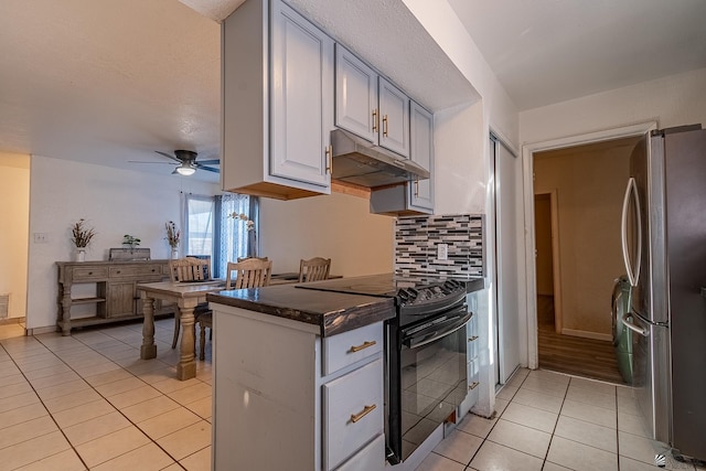 kitchen with backsplash, electric range, ceiling fan, light tile patterned floors, and stainless steel refrigerator