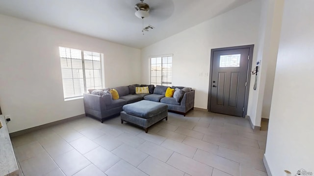 living area featuring lofted ceiling, baseboards, and ceiling fan