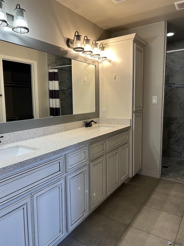 bathroom with curtained shower, tile patterned flooring, and vanity