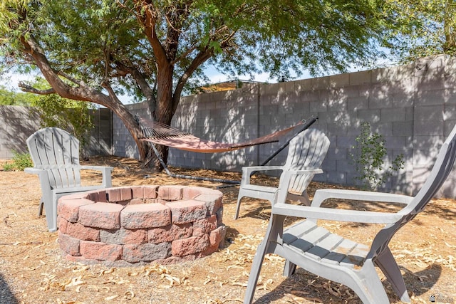 view of yard featuring a fire pit and fence