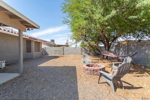 view of yard with a fenced backyard and an outdoor fire pit