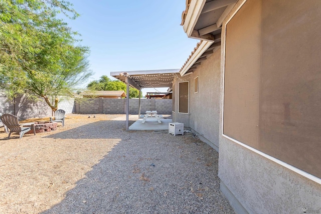 view of yard with a fenced backyard, a pergola, and a patio