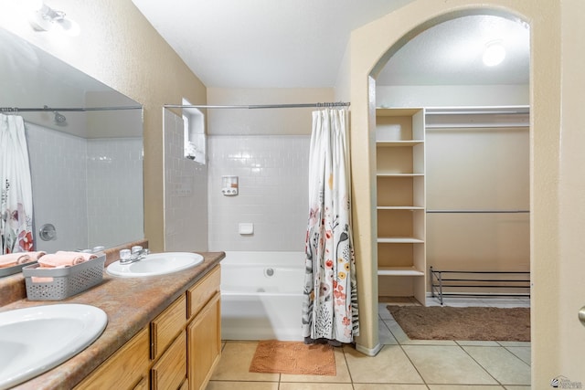 full bath with tile patterned floors, shower / bath combination with curtain, double vanity, and a sink