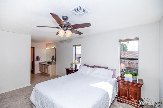 bedroom with ceiling fan and light colored carpet