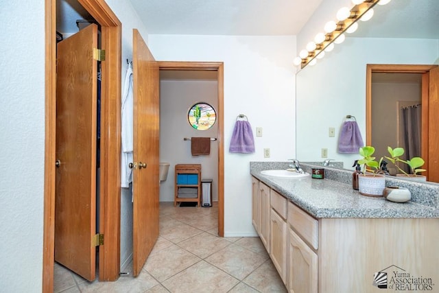 bathroom with tile patterned flooring and vanity