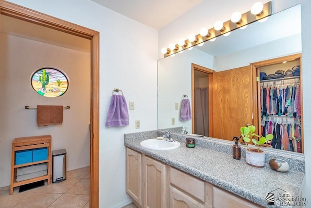 bathroom featuring tile patterned flooring and vanity