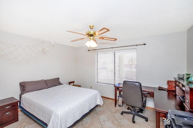 tiled bedroom featuring ceiling fan