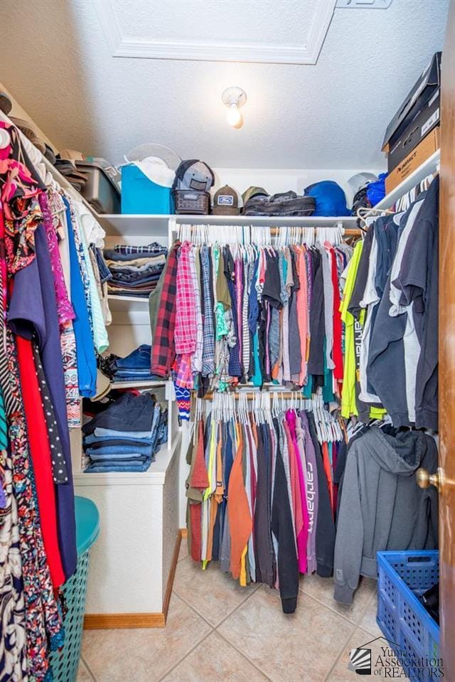 walk in closet featuring light tile patterned flooring