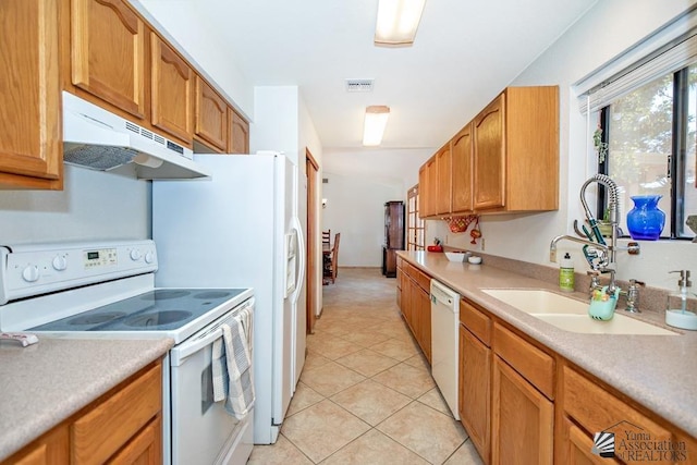 kitchen featuring sink, white appliances, and light tile patterned flooring