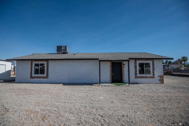 back of house with central AC unit