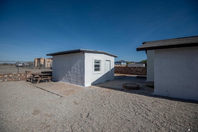 view of outbuilding featuring a fire pit