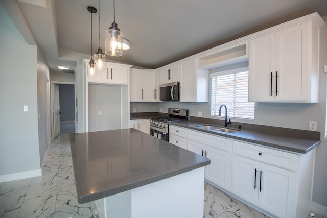 kitchen with a kitchen island, white cabinets, appliances with stainless steel finishes, and sink