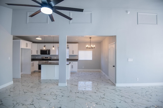 kitchen featuring decorative light fixtures, appliances with stainless steel finishes, and white cabinetry