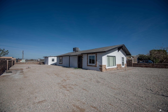 rear view of property featuring cooling unit