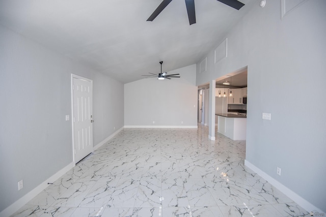 unfurnished living room with ceiling fan and vaulted ceiling