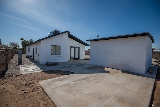 rear view of house featuring a patio, french doors, and central AC unit