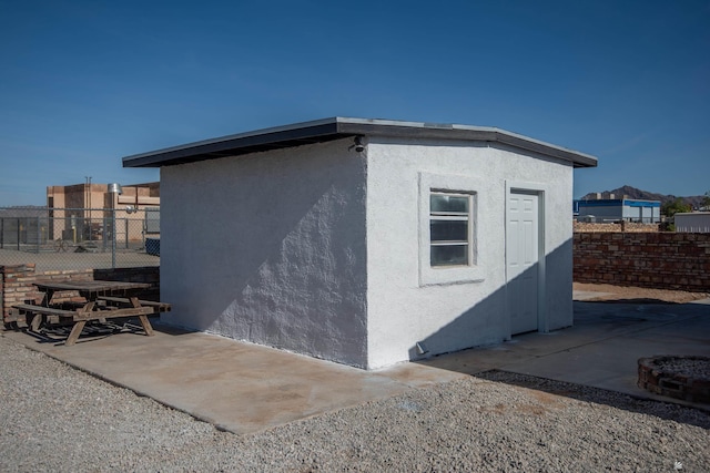 view of side of property featuring a patio area