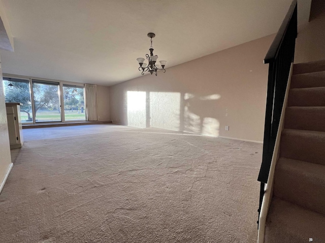 unfurnished living room featuring a chandelier, light colored carpet, and vaulted ceiling