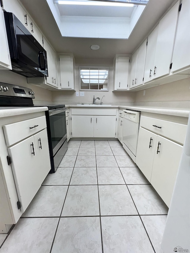 kitchen featuring stainless steel electric range, white cabinets, white dishwasher, sink, and light tile patterned floors