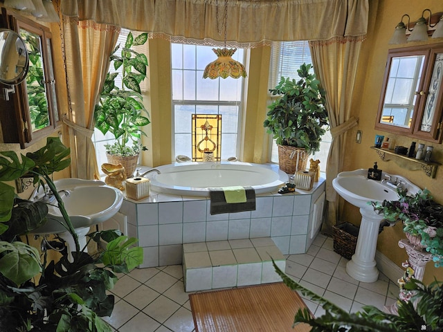 bathroom with tiled bath and tile patterned flooring